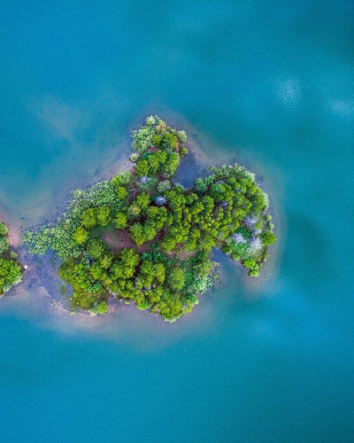 Drone picture of a small, green island